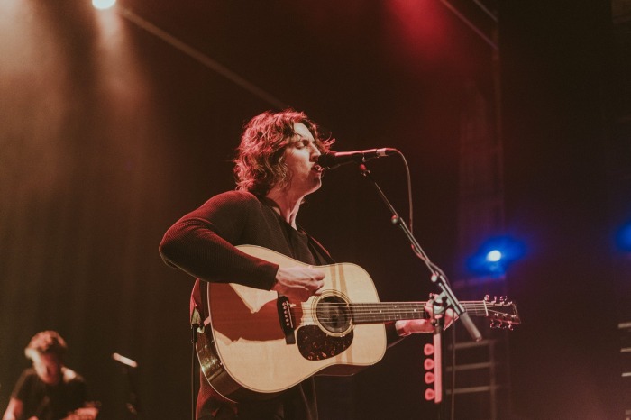 Dean Lewis playing the guitar at the Forum Melbourne